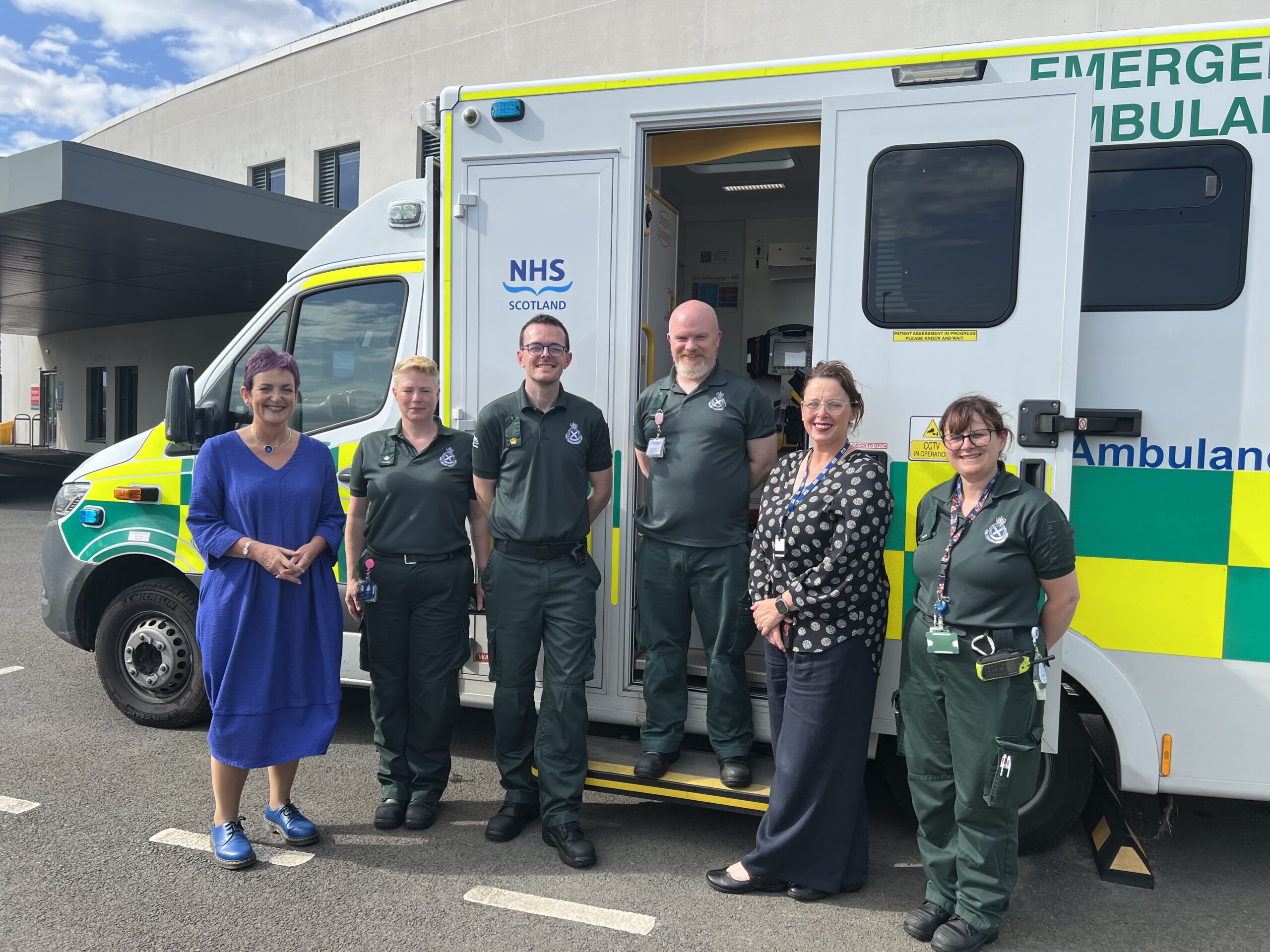 Ambulance staff standing outside ambulance vehicle