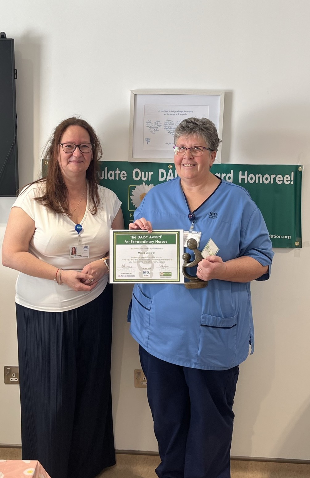 Photo of Sam Thomas presenting certificate to Morag Linklater